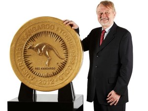 Manadatory Credit: Photo by Austral Int. / Rex Features (1482829d)  Perth Mint Chief Executive Officer Ed Harbuz with the one tonne, 99.99% pure gold coin  Perth Mint creates world's biggest, heaviest and most valuable gold bullion coin, Australia - 25 Oct 2011  The biggest, heaviest and most valuable gold bullion coin in the world has been unveiled by The Perth Mint. Weighing a massive one tonne, the 99.99% pure gold coin measures nearly 80cms wide and more than 12cms deep. According to Perth Mint Chief Executive Officer Ed Harbuz a team of talented artists and technical staff worked for months to create the coin.  He comments: "To cast and handcraft a coin of this size and weight was an incredible challenge, one which few other mints would not even consider". One side of the coin shows a red kangaroo surrounded by stylised rays of sunlight and bordered by the inscription 'AUSTRALIAN KANGAROO 1 TONNE 9999 GOLD' and the year-date 2012. Issued as Australian legal tender, the other side features an effigy of Her Majesty Queen Elizabeth II, accompanied by the inscriptions ELIZABETH II, AUSTRALIA and the monetary denomination of  1 MILLION DOLLARS.
